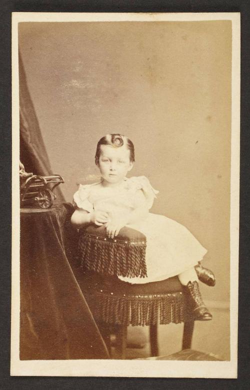 Unknown sitter [portrait of a seated child with a curl hair on forehead]