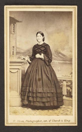 Unknown sitter [portrait of a standing woman with her right hand on pedestal]