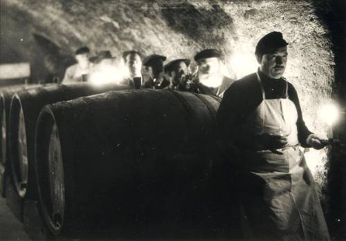 The ceremonial act of wine-tasting in the small Rhenish village of Rauhental which is popular with connoisseurs because of its fine wines. The guests are shown around by the head of the wine cellars.