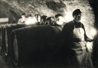 The ceremonial act of wine-tasting in the small Rhenish village of Rauhental which is popular with connoisseurs because of its fine wines. The guests are shown around by the head of the wine cellars.
