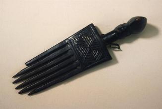 Comb with decoration in the shape of a female head