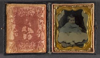 Portrait of baby in blue jacket (seated on lap)