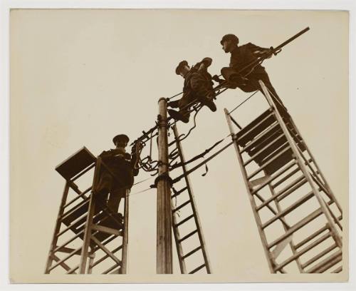 Modern Aladdins, erecting lamp standards, London