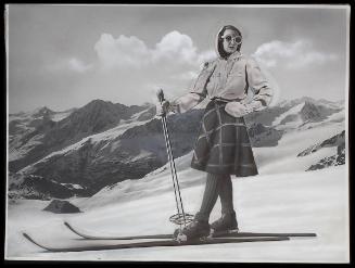 Model, mountains, standing on skis.