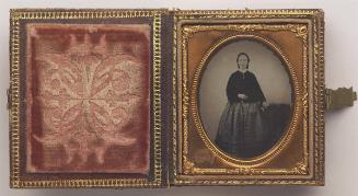 Unknown sitter: Portrait of woman standing, wearing dark jacket