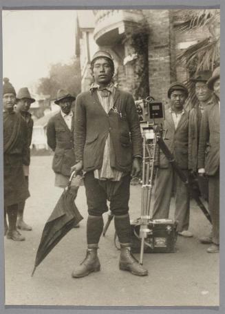 The Dandy of Darjeeling. A complete western outfit, even down to watch chain and clip-on pencil, and of course the umbrella must not be left behind; it is the insignia of the fashionable man in Darjeeling.