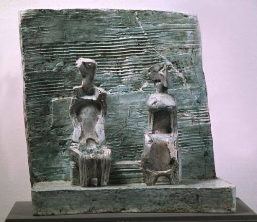 Two Seated Girls against Wall