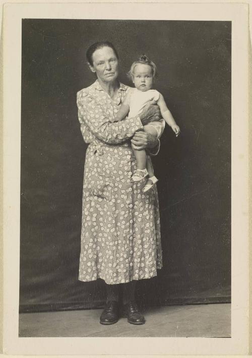 [Woman holding child]