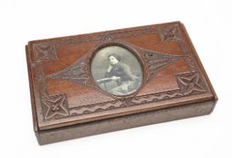 Box with "Portrait of a woman seated at table" photograph inset in lid