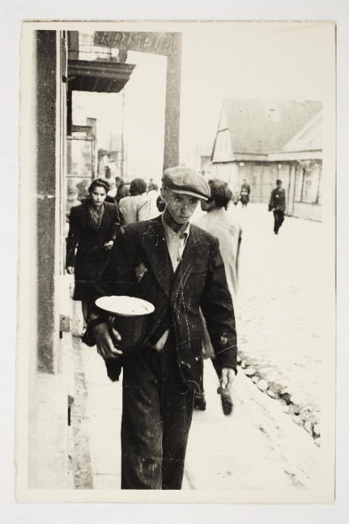 Hungry man walking on the street with a pail and empty plate