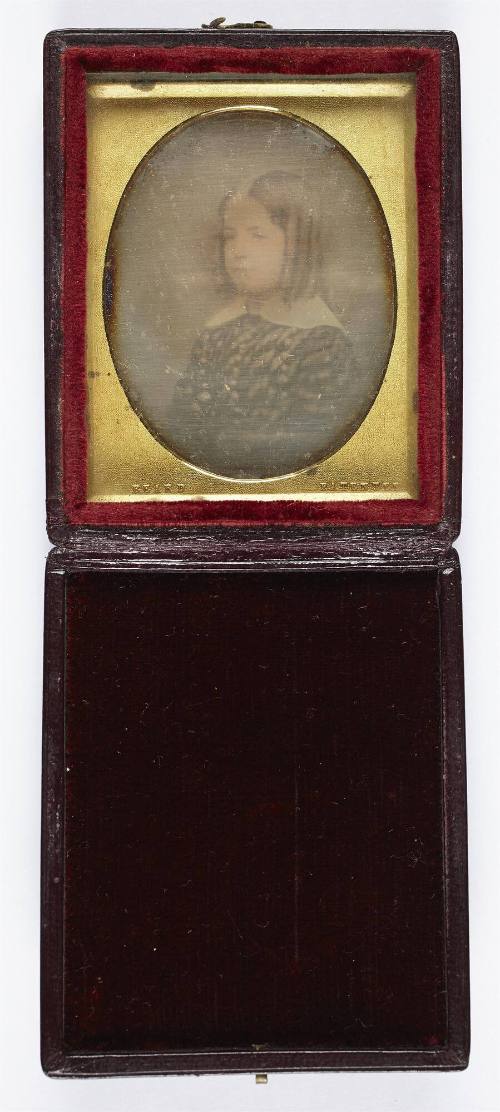 [Portrait of a young girl with curls]