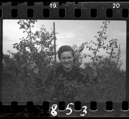 Young ghetto girl looking through shrubs