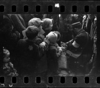 Postal worker distributing goods to children and residents in the ghetto