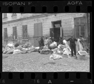 Residents sorting belongings left behind after deportation
