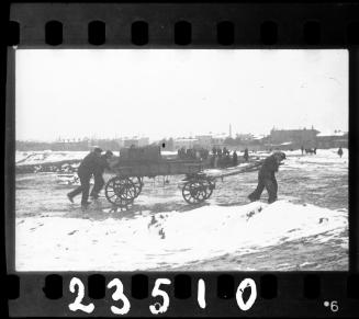 Fecal workers hauling a sewage collecting tank mounted on a wagon, in winter