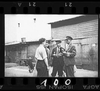 Dr. Leider, the veterinarian, standing with three men in the ghetto