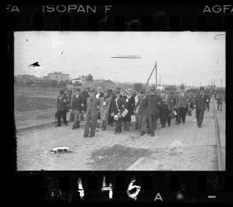 Large group of residents and policemen carrying belongings during deportation from the Lodz Ghetto