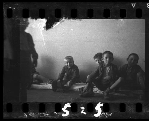 Children sitting on floor mats, probably in the ghetto orphanage