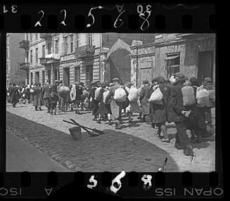 View from behind of residents with sacks heading for deportation