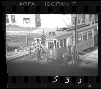 Jewish police opening the entry gate for a streetcar