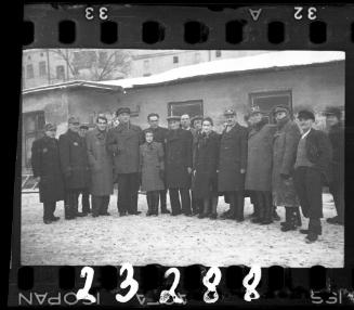 Workers of the Transport Department standing outside of a building in the winter