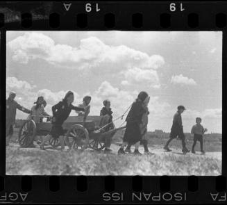 Residents pulling a hearse through the ghetto