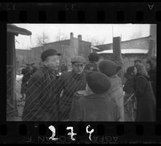 Residents talking through the prison fence