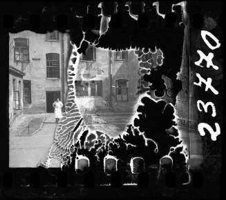 Resident walking in the courtyard of a ghetto building