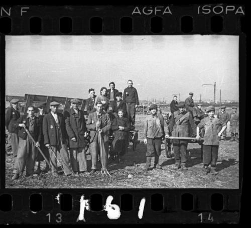 Group of workers with agricultural tools in a field in the ghetto