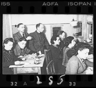 Men and women working in an office in the ghetto