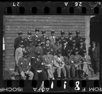 Group portrait of Jewish policeman and a member of the Transport Department outside an unidentified building