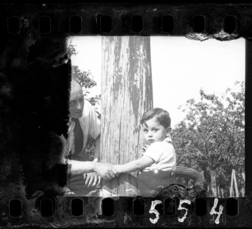 Man holding a boy by his hand