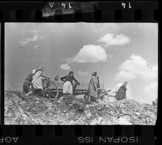 Residents pulling a hearse through the ghetto