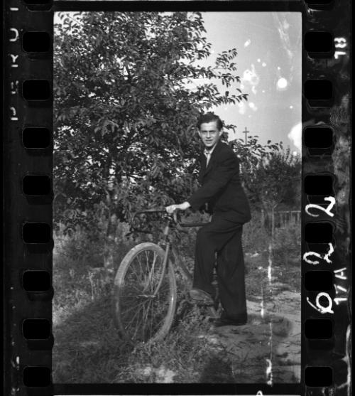 Young man holding a bike