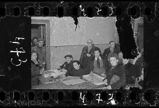 Men and women working in an office in the ghetto