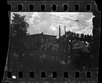 View of residents crossing the Zigerska Street bridge, over the "Aryan" street that divided the ghetto into two areas