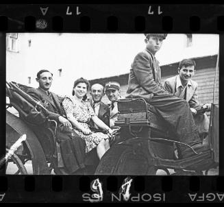 Residents and policeman in carriage