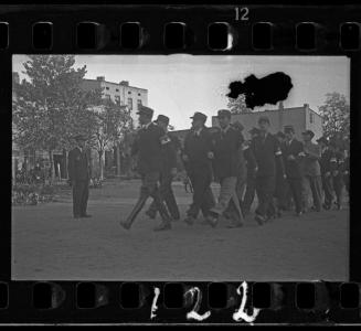 Jewish policemen marching through the ghetto