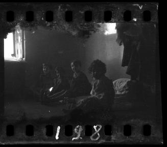 Four children sitting on floor mats