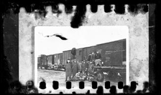 Photograph of German officials and ghetto residents outside train at Radogoszcz Station