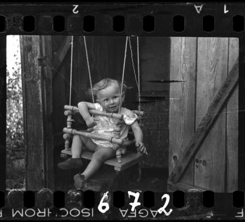 A boy in a doorway swing