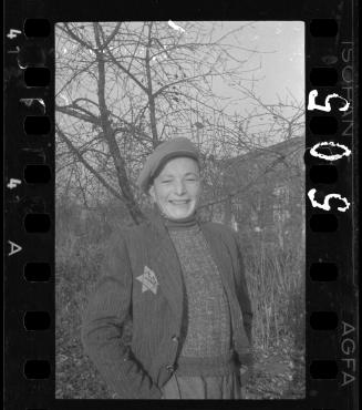 Jewish boy smiling against bare trees