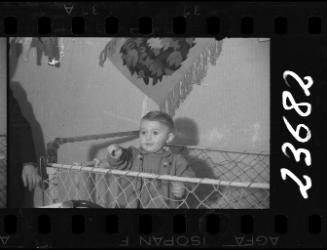 Portrait of a young child in a crib