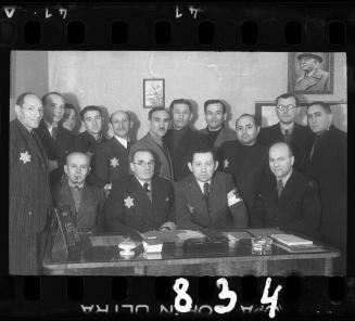 Group portrait of members of the ghettto administration in an office