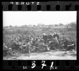 Group of young men sitting in a field in the ghetto