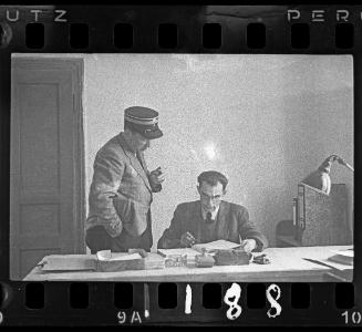 A Jewish policeman and an administrator sitting at his desk