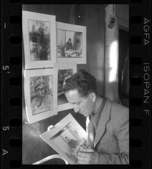 Mendel Grossman with portraits of German officers and administrators