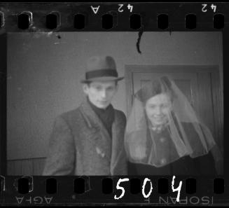 Portrait of a couple in the ghetto; woman wearing a veil
