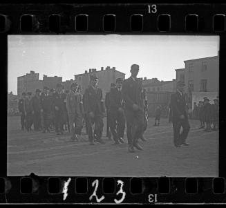 Jewish policemen marching through the ghetto