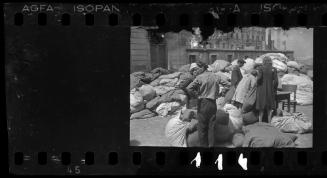 Residents sorting belongings left behind after deportation